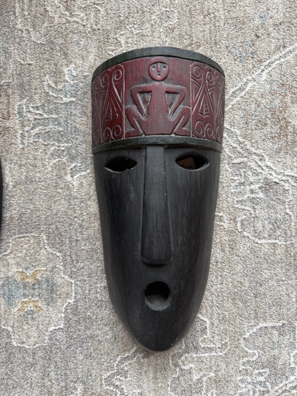 Hand carved tribal wooden mask in black and deep red